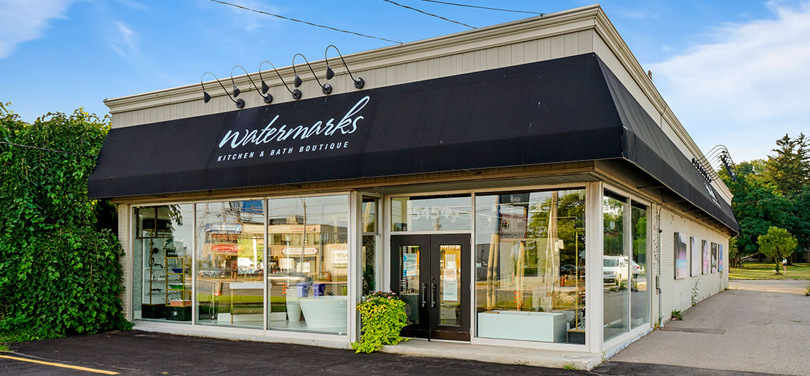 Standalone storefront with large black awning wrapping around the building on two sides. Located at 5454 Dundas Street West, Etobicoke, Ontario.