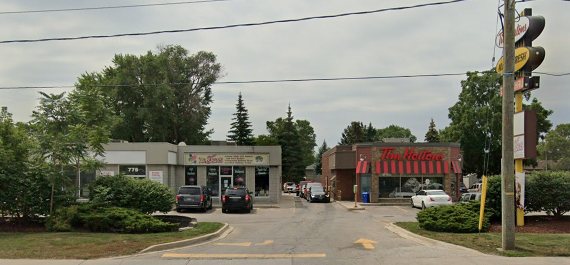 Streetview of entrance to two storefronts and parking lots. Located at 775 Exmouth Street, Sarnia, Ontario.