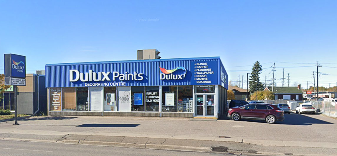 Single story free standing store front with large blue facade and street facing windows. Located at 784 Memorial Avenue, Thunder Bay, Ontario